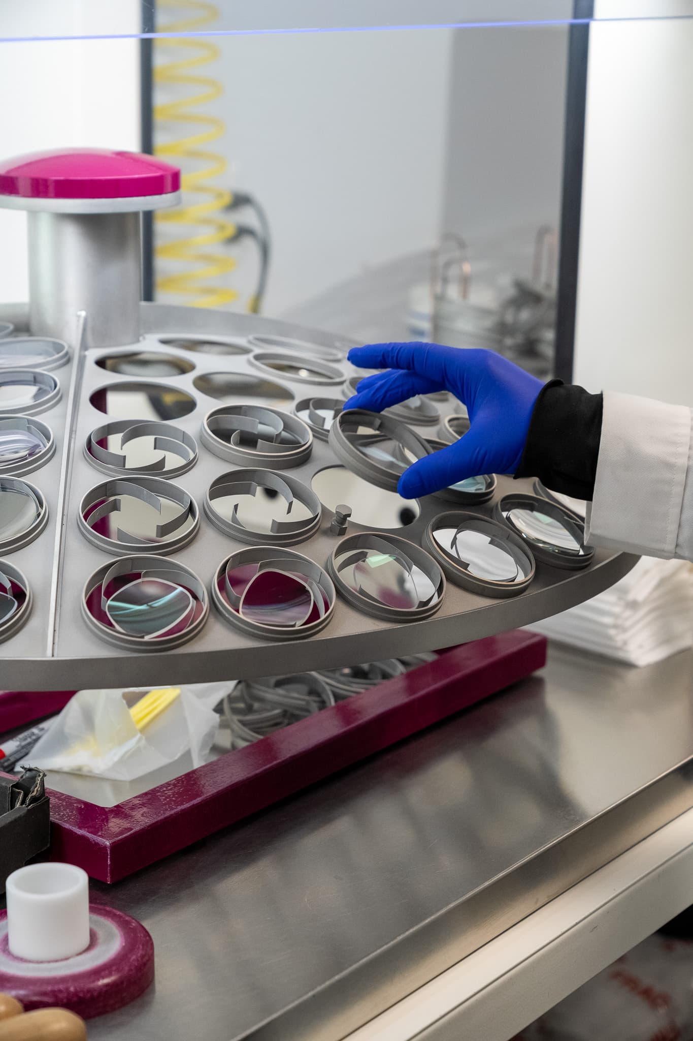A technician loading lenses for coating at the EyeKraft lab