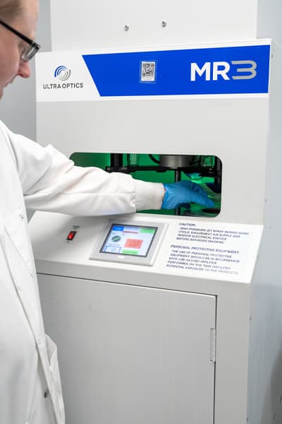 A technician at a lens cleaning system